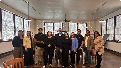 Capital Connect participants and facilitators standing together in a meeting room