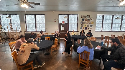 Business owners talking in small groups around round tables